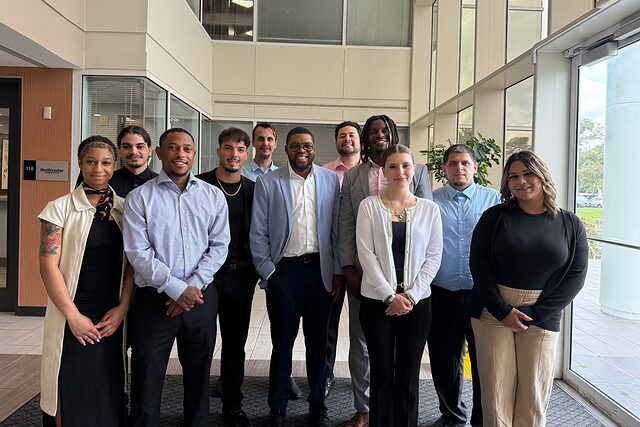 Channel Focus team members standing together in an office building atrium