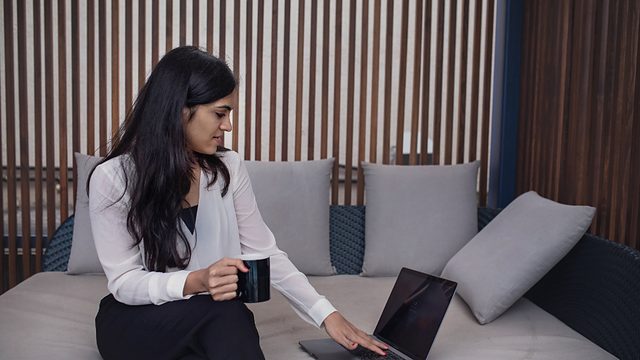 Marketer working on a laptop while seated