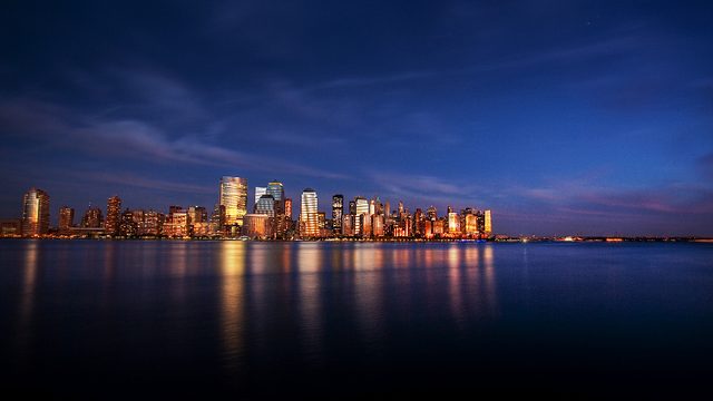 City skyline at dusk reflected in the water