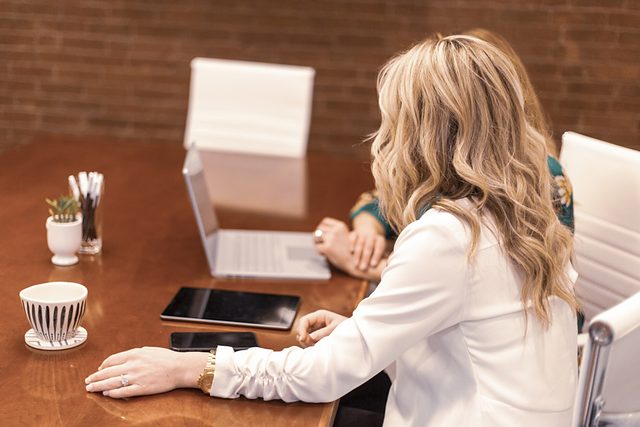 Professional working at a tidy desk with a laptop