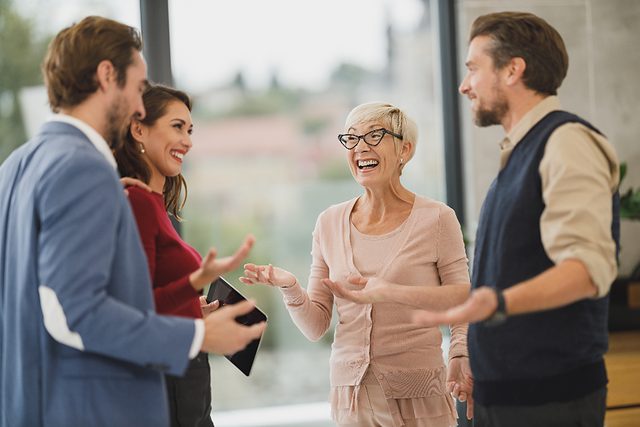 Business professionals talking face to face in an office