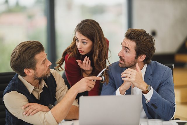Colleagues reviewing work together during a coaching session