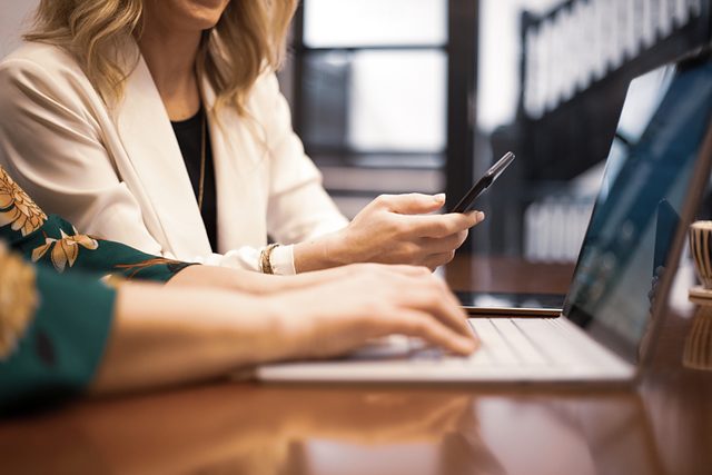 Professional working at a laptop in a bright office